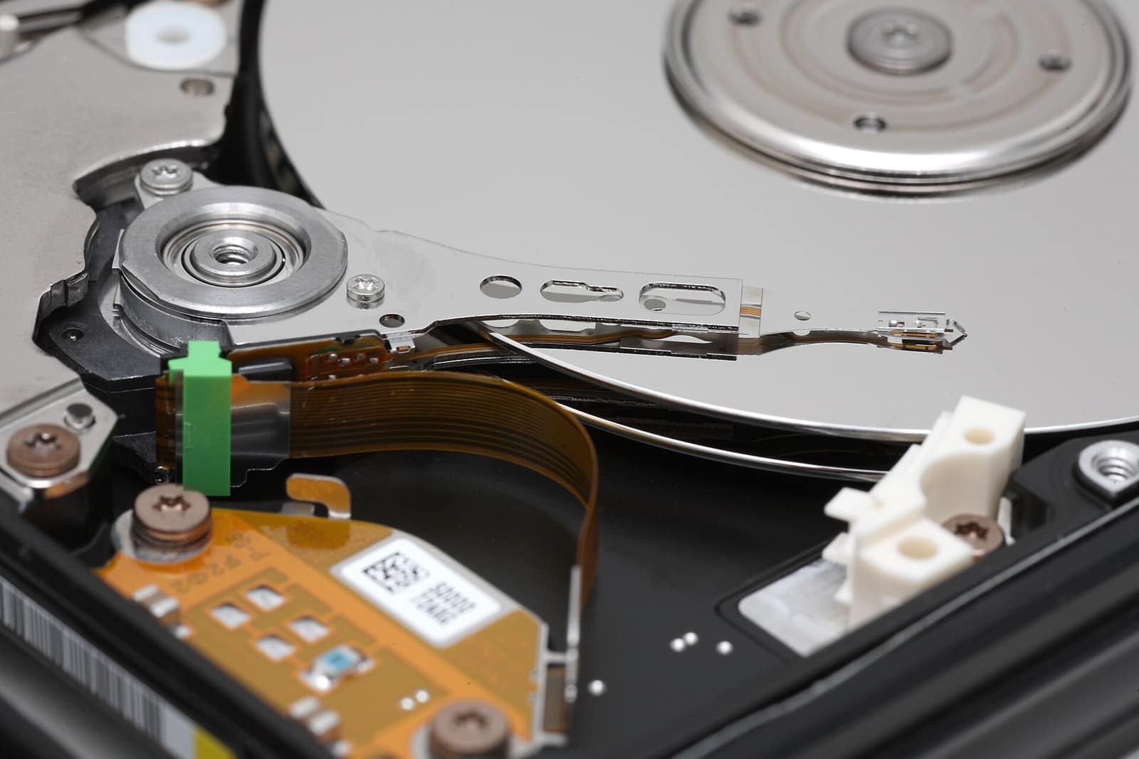 Inside a hard disk: the read and write arm resting over a mirrored platter